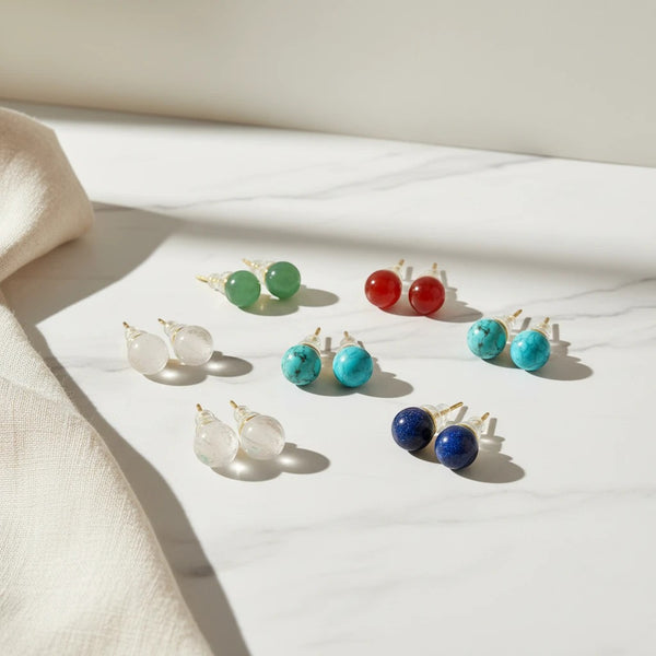 Elephantina.gr assorted semi-precious stone stud earrings in green, red, turquoise, lapis lazuli, and clear quartz.