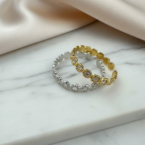 Elephantina.gr adjustable steel ring with white stones, available in gold or silver finish, featuring a circular pattern.