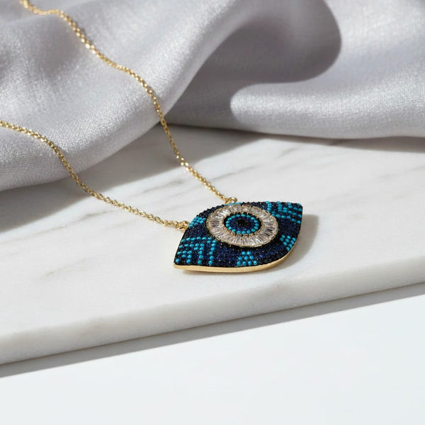 Elephantina.gr gold-tone stainless steel evil eye necklace with blue and black zircon stones and a central clear crystal.