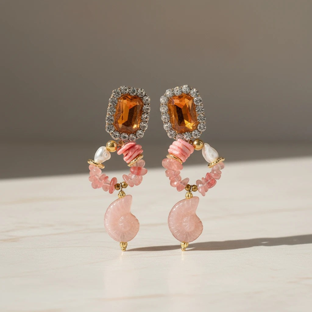 Elephantina.gr statement drop earrings with amber-colored gems, crystals, pink chips, pearls, coral beads, and ammonite fossils.