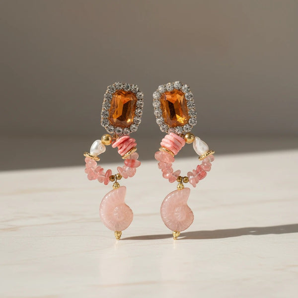 Elephantina.gr statement drop earrings with amber-colored gems, crystals, pink chips, pearls, coral beads, and ammonite fossils.