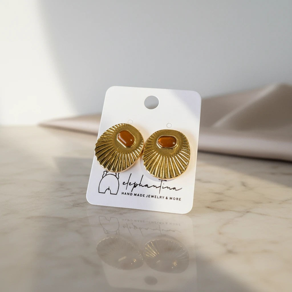elephantina.gr vintage-inspired gold-tone stud earrings with textured sunburst design and oval amber cabochon.