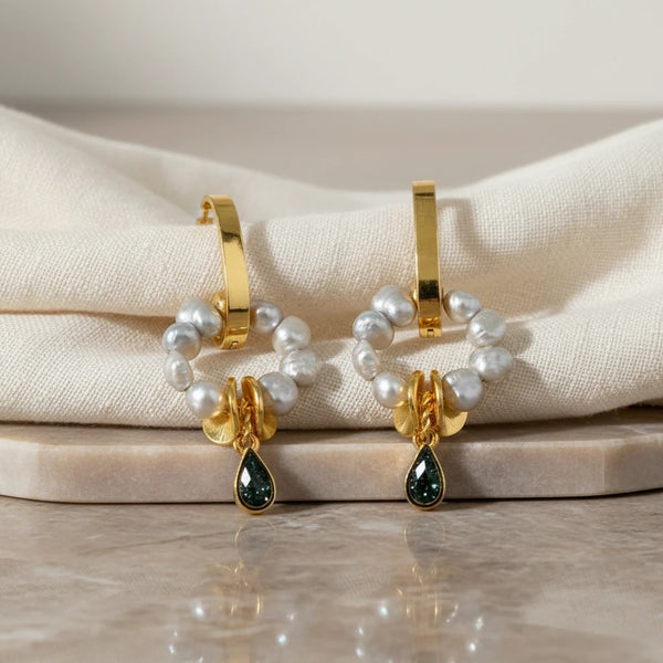 elephantina.gr gold hoop earrings with grey baroque pearls and a black glitter enamel teardrop charm.