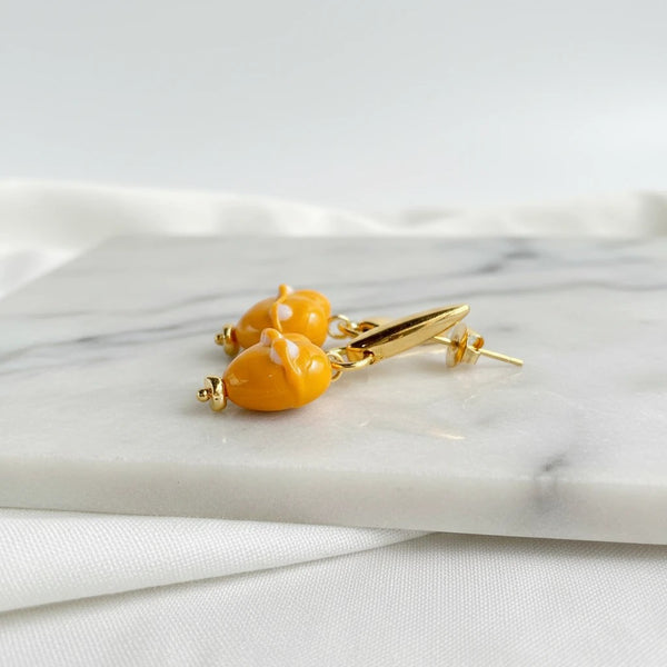 elephantina.gr handmade mustard heart earrings with white enamel details and gold-tone metal accents
