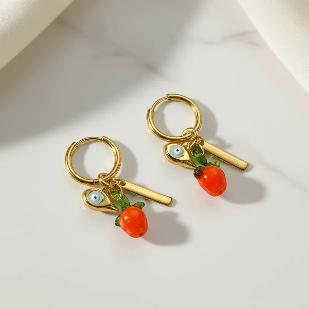 Elephantina.gr gold hoop earrings with red glass pepper charm and evil eye detail.