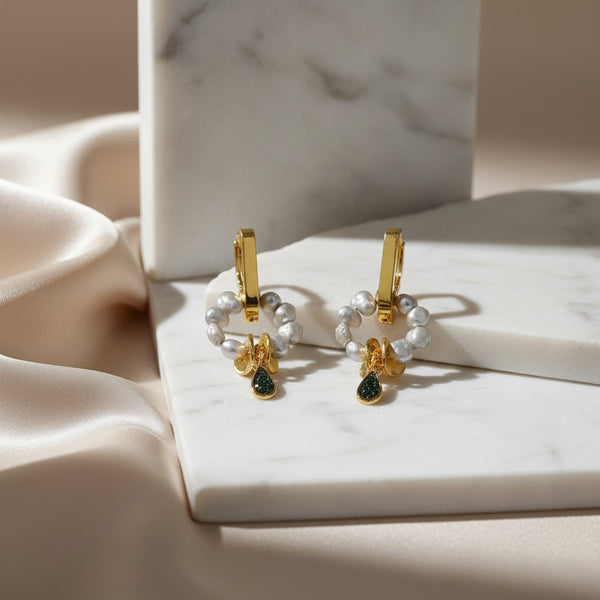 elephantina.gr gold hoop earrings with grey baroque pearls and a black glitter enamel teardrop charm.