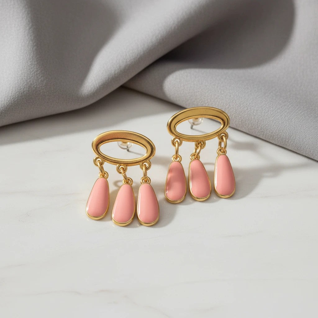 elephantina.gr handmade gold oval earrings with dangling peach enamel teardrops. Stud backing.