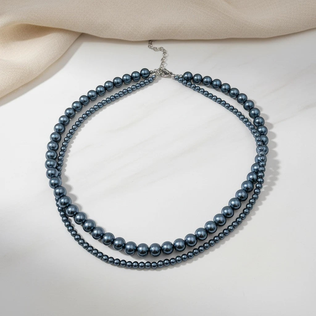 Elephantina.gr double strand pearl necklace in metallic grey, with pearls of varying sizes and gold clasp. 40cm + 5cm extension.