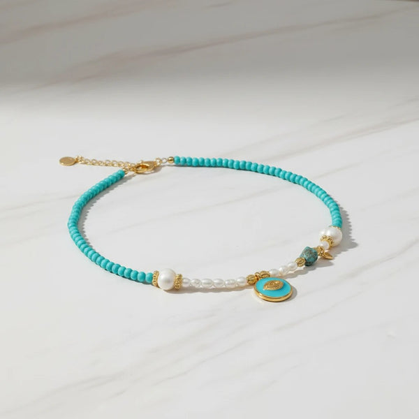 Elephantina.gr Aegean Eye necklace with freshwater pearls, turquoise beads, and gold eye charm. Adjustable length.