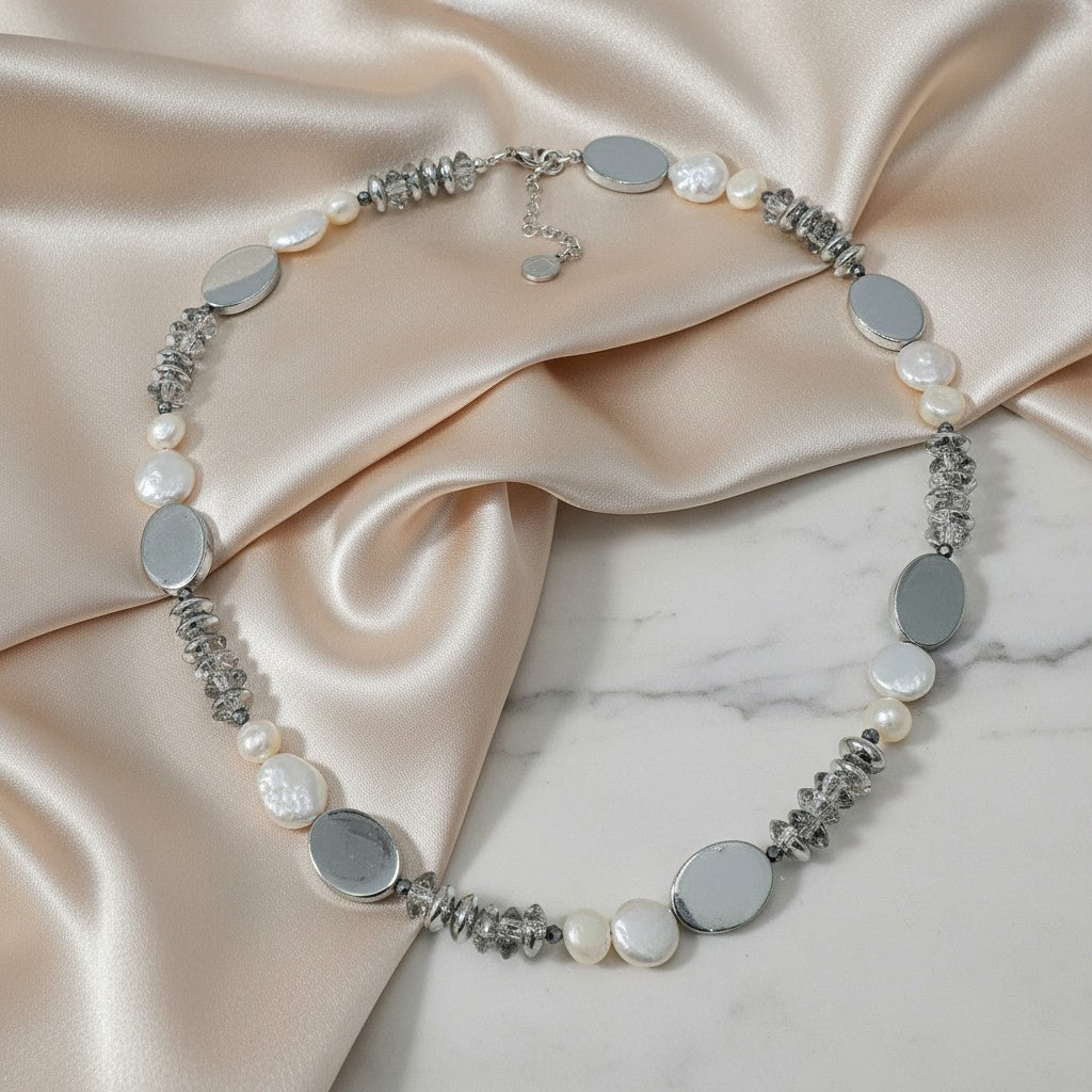 elephantina.gr handmade necklace with white freshwater pearls, silver hematite, and clear glass crackle beads. Features oval silver charms.