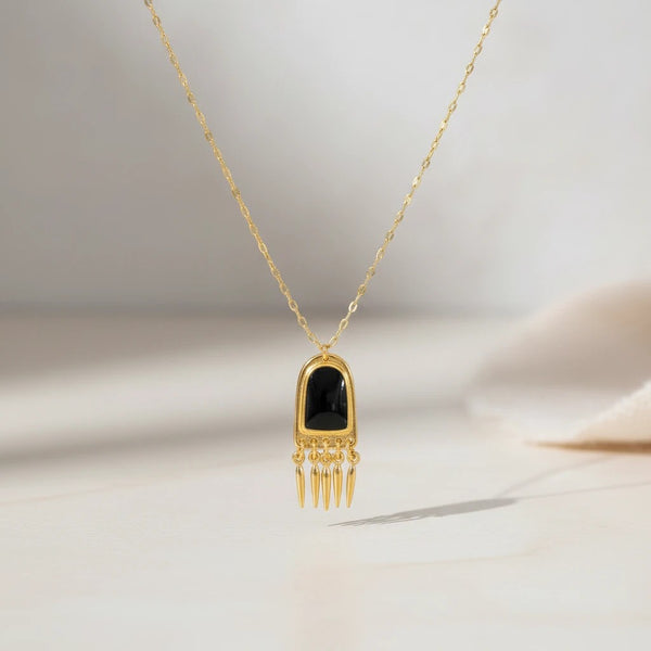 Elephantina.gr gold-tone necklace with black enamel pendant and dangling spike charms. Steel chain, 45cm + 5cm extension.