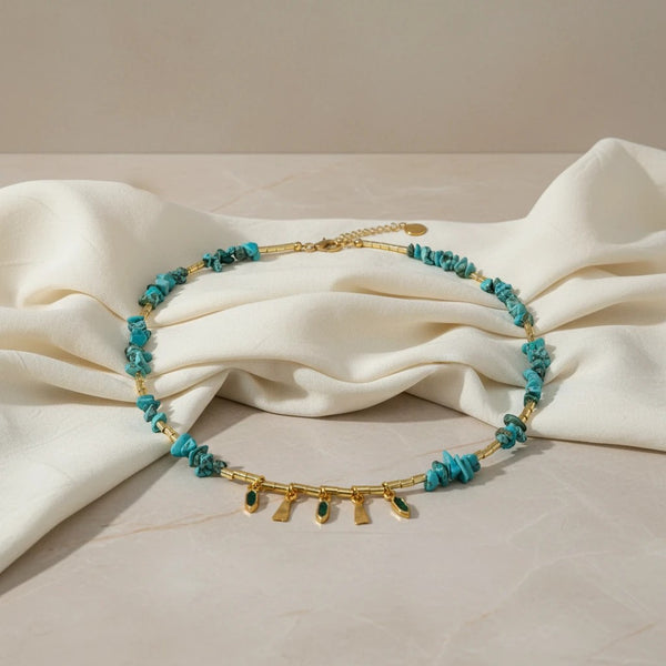 Elephantina.gr handmade boho necklace with turquoise stones and gold details. Features dangling charms and adjustable clasp.