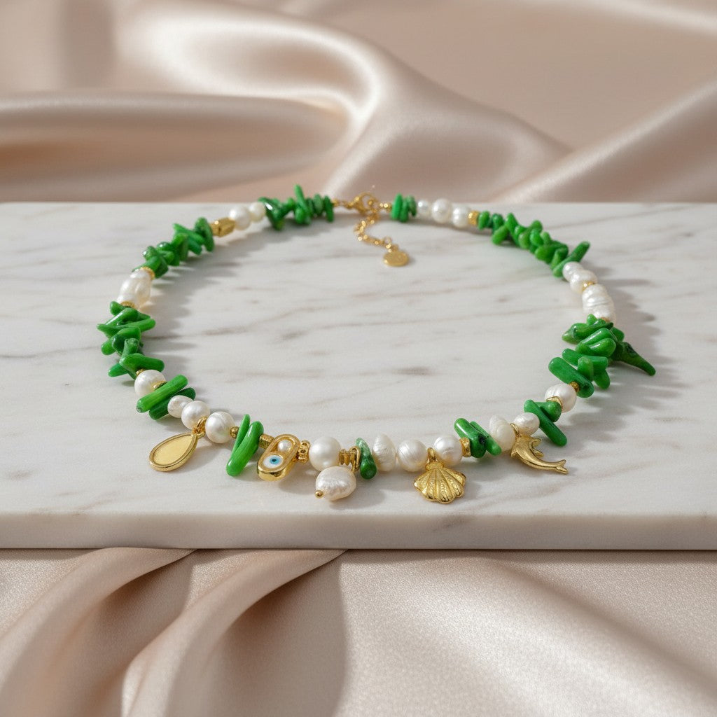 Elephantina.gr "Thalassa Verde" necklace with pearls, green coral, and gold sea charms like a dolphin and shell.