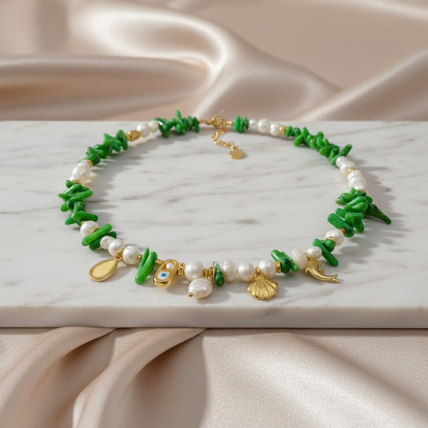 Elephantina.gr "Thalassa Verde" necklace with pearls, green coral, and gold sea charms like a dolphin and shell.