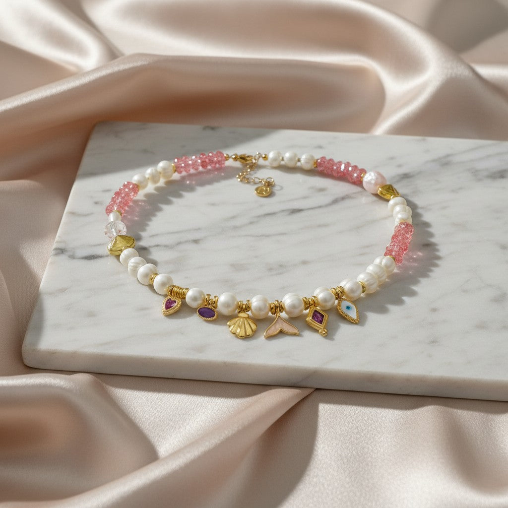 Elephantina.gr Aphrodite necklace with pearls, pink beads, and sea charms like shells and mermaid tails.