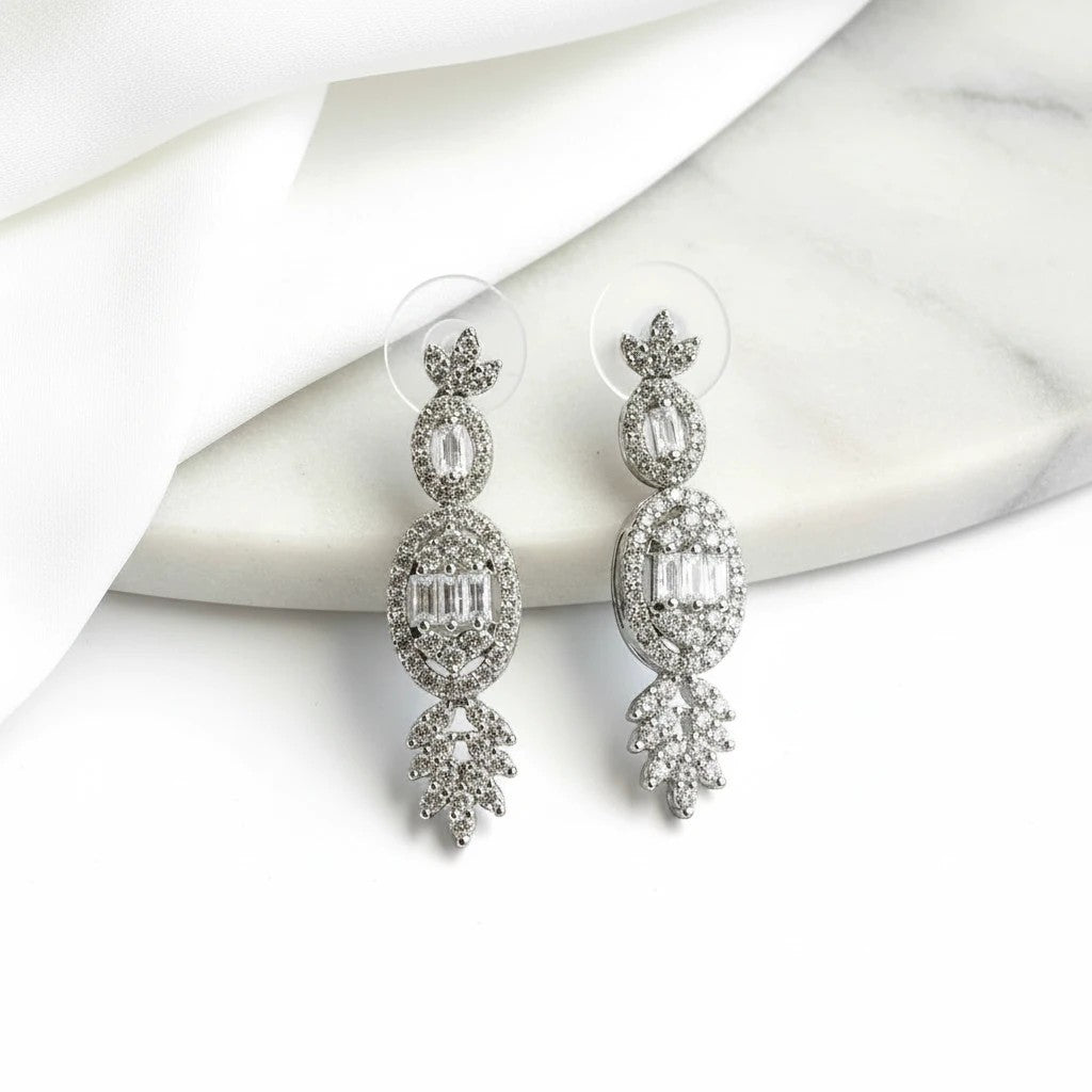 elephantina.gr Phos silver-plated bridal stud earrings with white crystals and zircon on a marble surface.