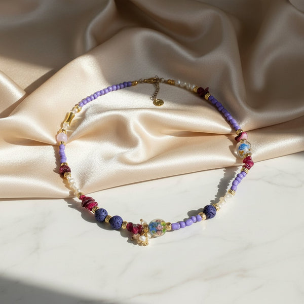 Elephantina.gr handmade necklace with purple beads, mix stones, pearls, and a glass charm. Gold-plated clasp.