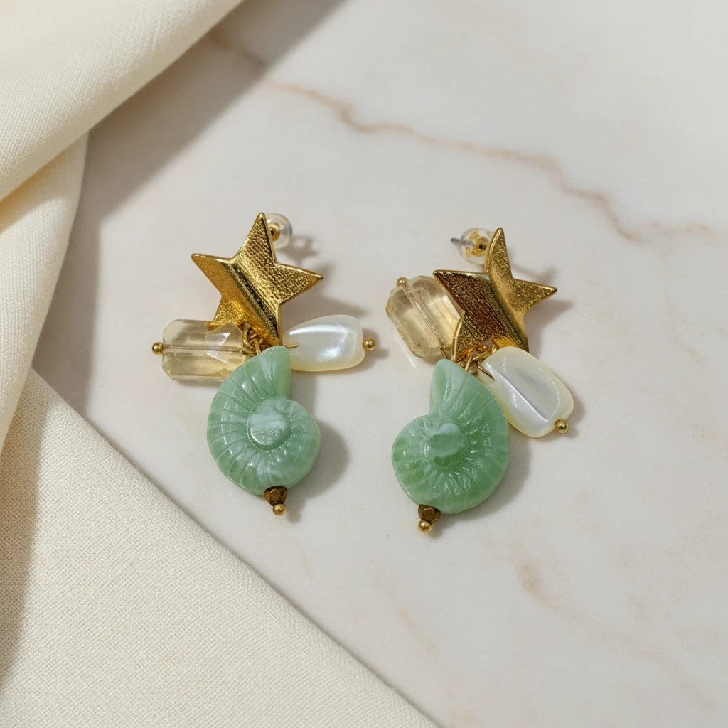 Gold Star Shell Charm Dangle Earrings by elephantina.gr featuring green ammonite fossil charms, pearl beads, and crystals.