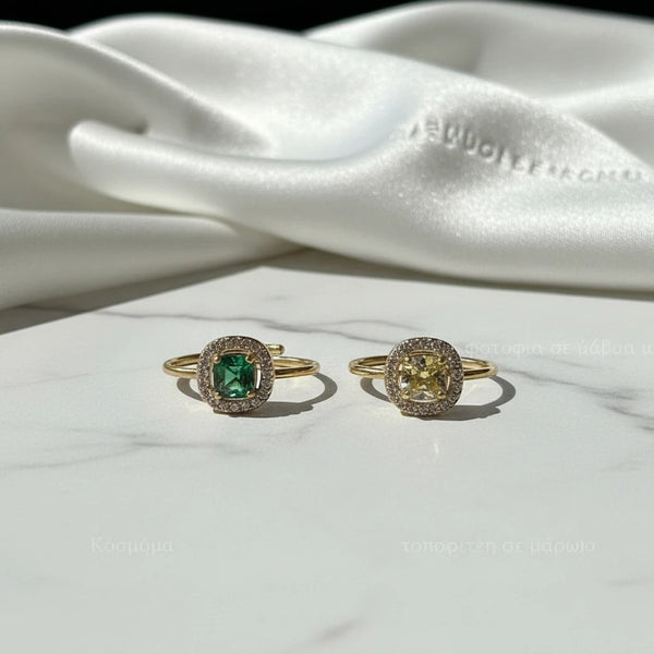 elephantina.gr adjustable gold-tone rings with emerald green and yellow cushion-cut stones and pavé crystal halos.