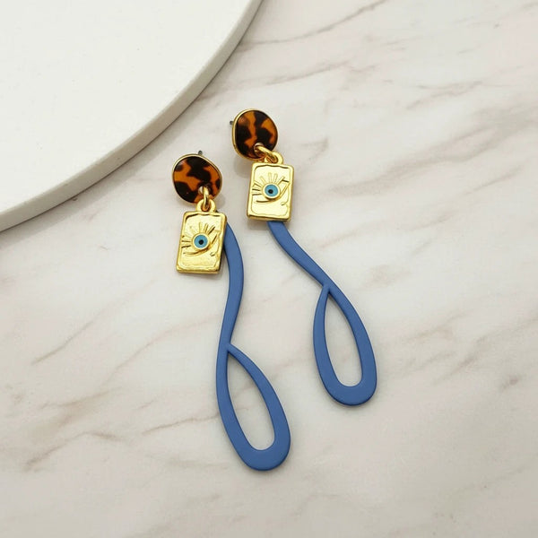 Elephantina.gr gold-plated earrings with blue silicone abstract shape and evil eye charm. Modern design.