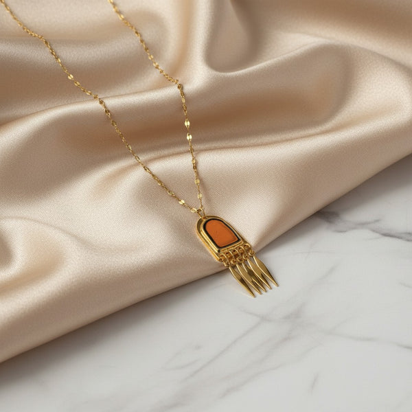 Gold tone necklace with a pendant featuring brown enamel and gold-plated brass comb-like elements. Elephantina.gr