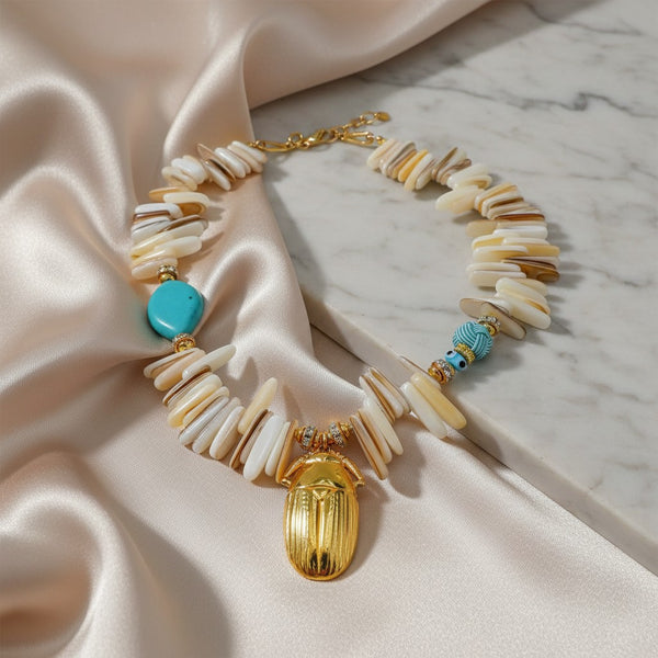 Elephantina.gr handmade necklace with natural shell chips, turquoise, blue zircon, and gold scarab charm. Boho style.