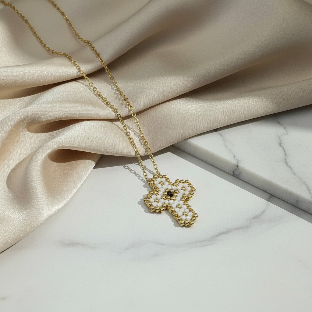 elephantina.gr handmade cross necklace with white Miyuki beads and stainless steel chain. Features a gold-tone finish.