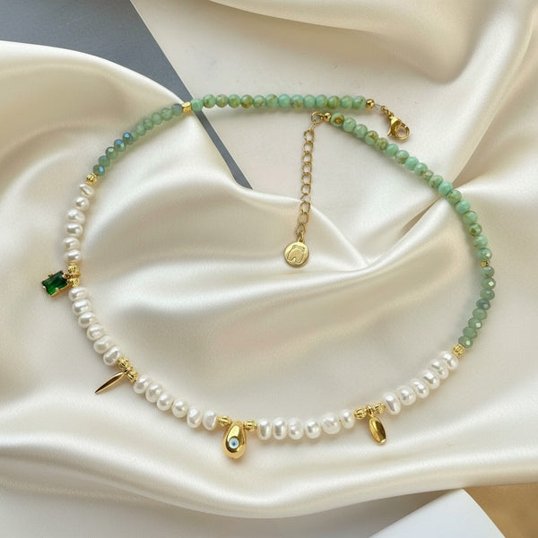 Elephantina.gr handmade necklace with pearls, green beads, gold eye charm, and emerald green accent.