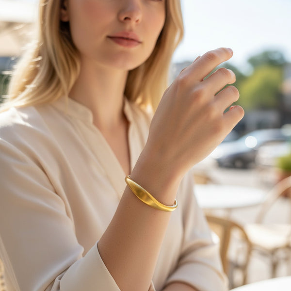 elephantina.gr gold-tone stainless steel cuff bracelet with a smooth, curved design. Minimalist and elegant.