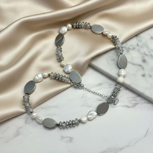 Elephantina.gr handmade necklace with white freshwater pearls, silver hematite, and glass beads. Features an adjustable silver chain.