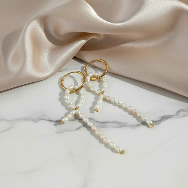 elephantina.gr gold-plated hoop earrings with dangling rice-shaped cultured pearl ribbons on marble background
