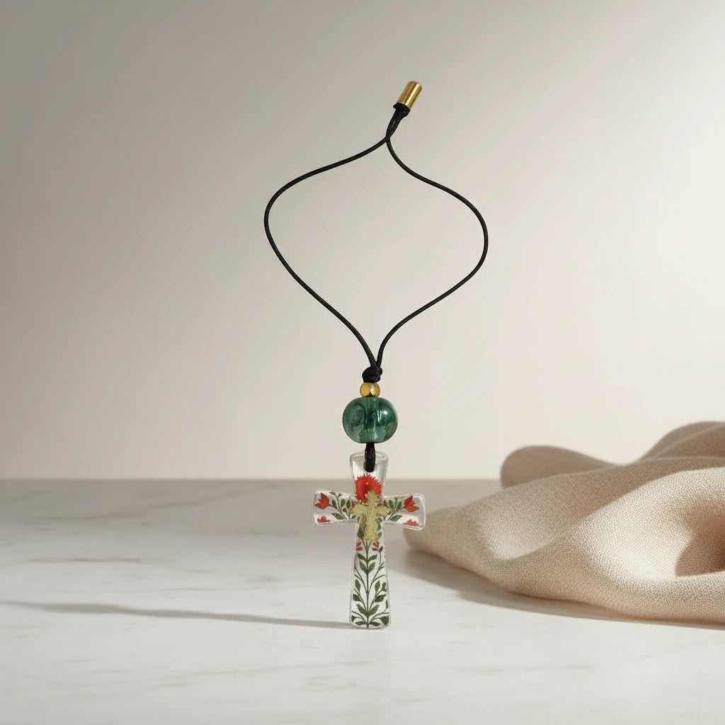 Decorative cross pendant necklace with floral motif, green bead, and gold accent by elephantina.gr
