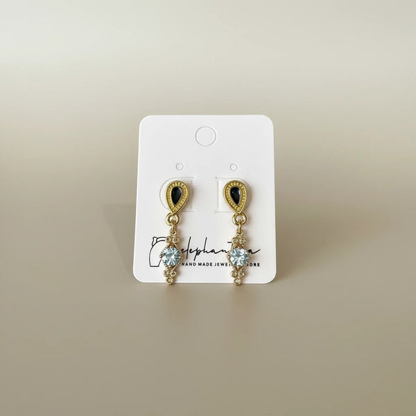 Elegant black teardrop dangle earrings with cubic zirconia accents and gold-tone metal by elephantina.gr