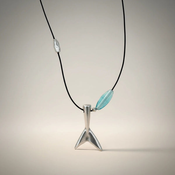 Silver whale tail pendant necklace with blue glass bead and silver bead on black cord by elephantina.gr