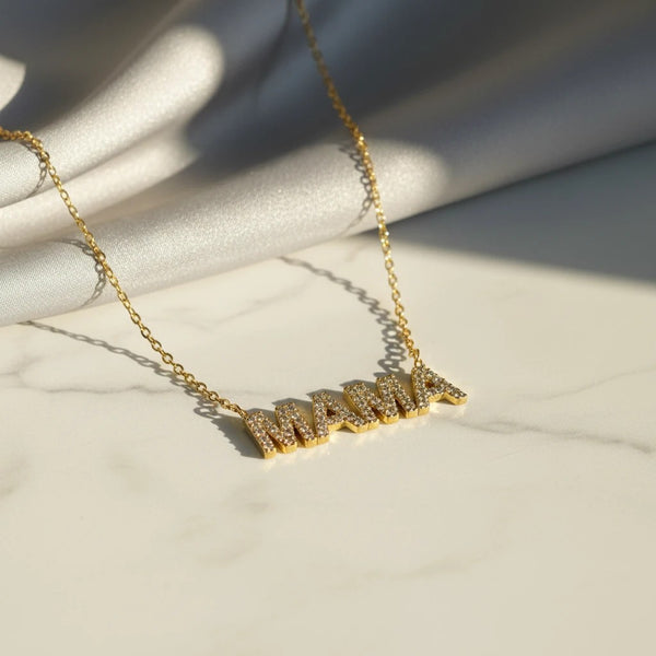 Gold plated stainless steel necklace with "MAMA" pendant encrusted with white zircons. 40cm chain with 5cm extension.
