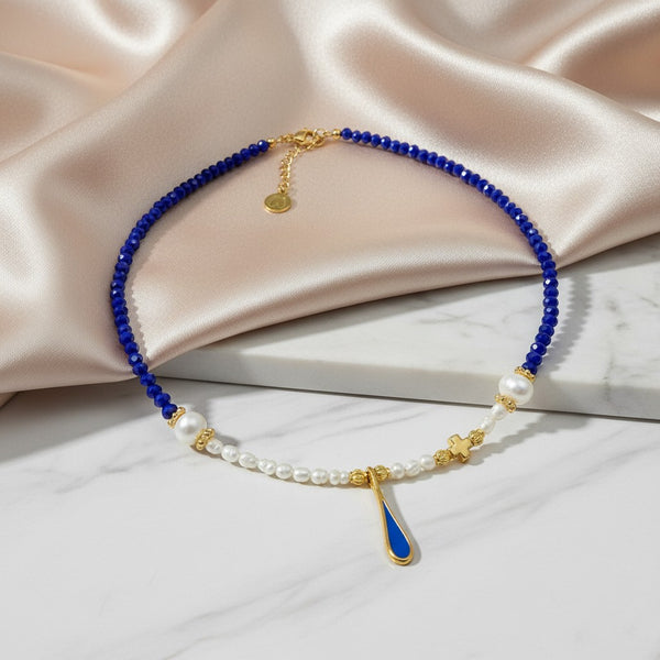 elephantina.gr blue crystal and pearl necklace with gold enamel drop and cross charm. Adjustable.