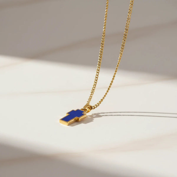 Gold-tone chain necklace with a blue cross pendant from elephantina.gr. Modern, classic symbol with vibrant blue inlay.