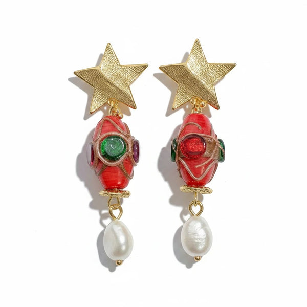 elephantina.gr 24k gold-plated star earrings with red glass beads, colorful accents, and dangling baroque pearls.