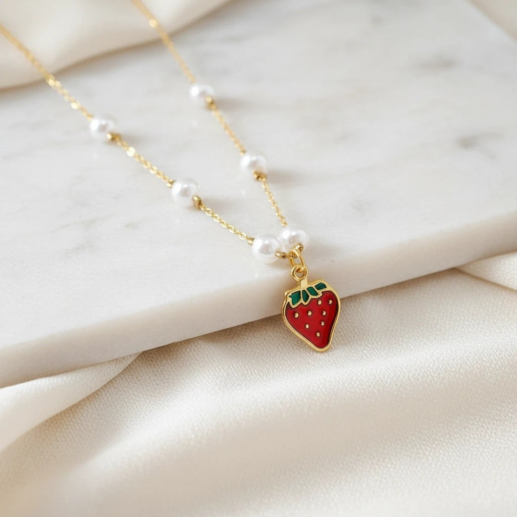 Gold stainless steel necklace with pearls and a red strawberry charm from elephantina.gr