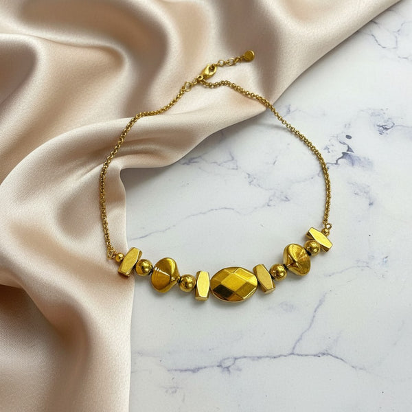elephantina.gr gold hematite and steel chain necklace with geometric modern design and faceted stones.