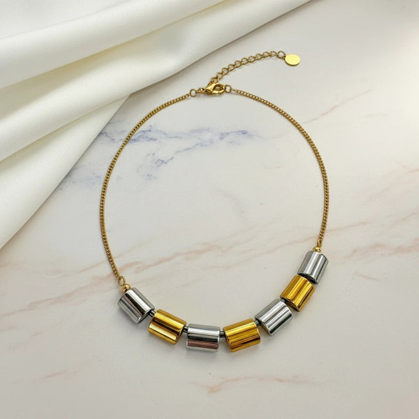 elephantina.gr gold necklace with alternating silver and gold cylindrical hematite beads on a thin gold chain. Minimalist design.
