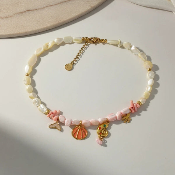 Elephantina.gr mother of pearl and pink beaded necklace with shell, starfish, and seahorse charms. Boho summer design.
