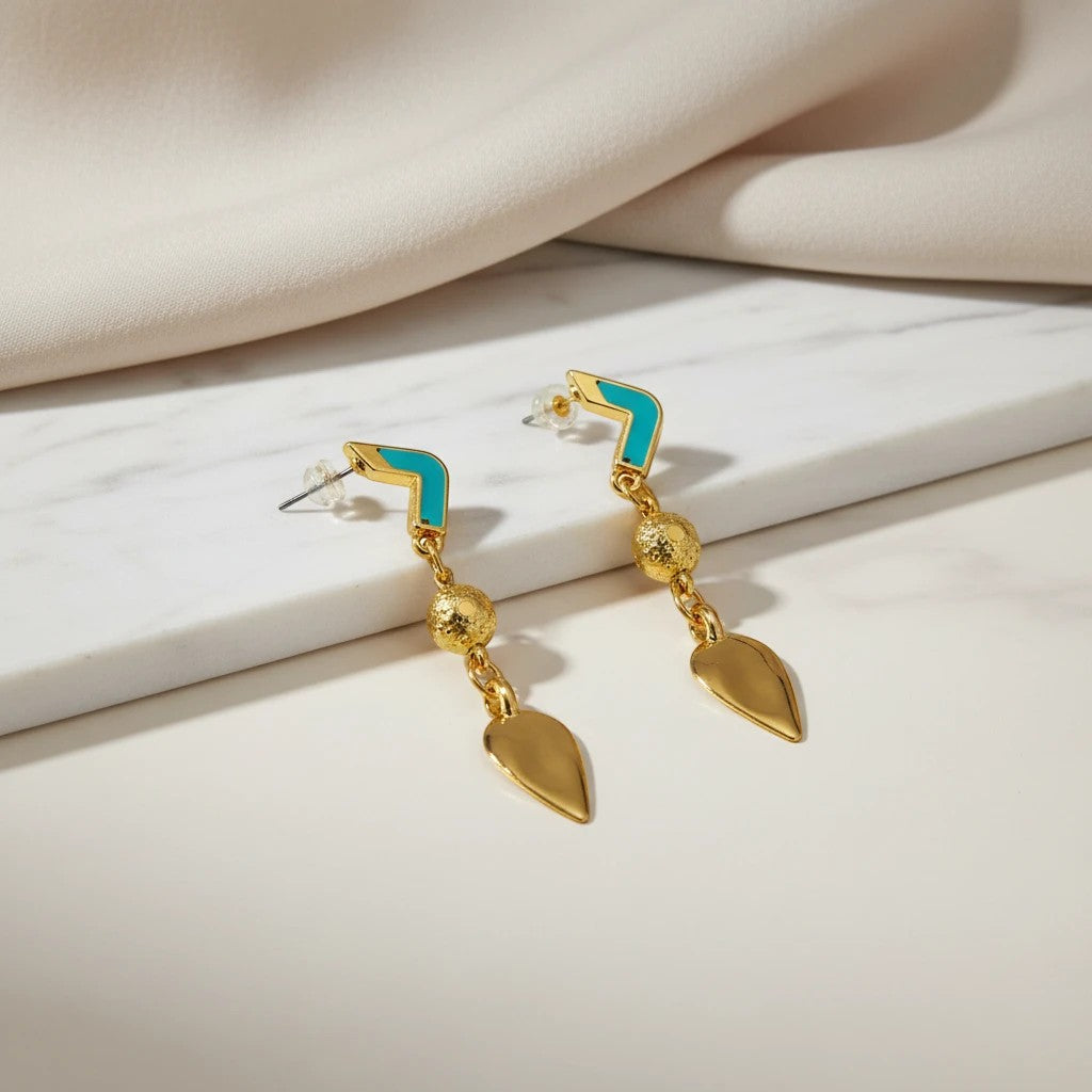 elephantina.gr gold-tone drop earrings with turquoise chevron studs, textured beads, and leaf charms.