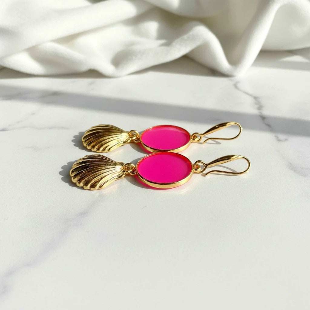 elephantina.gr gold-plated drop earrings with fuchsia enamel circles and shell charms on a white marble surface
