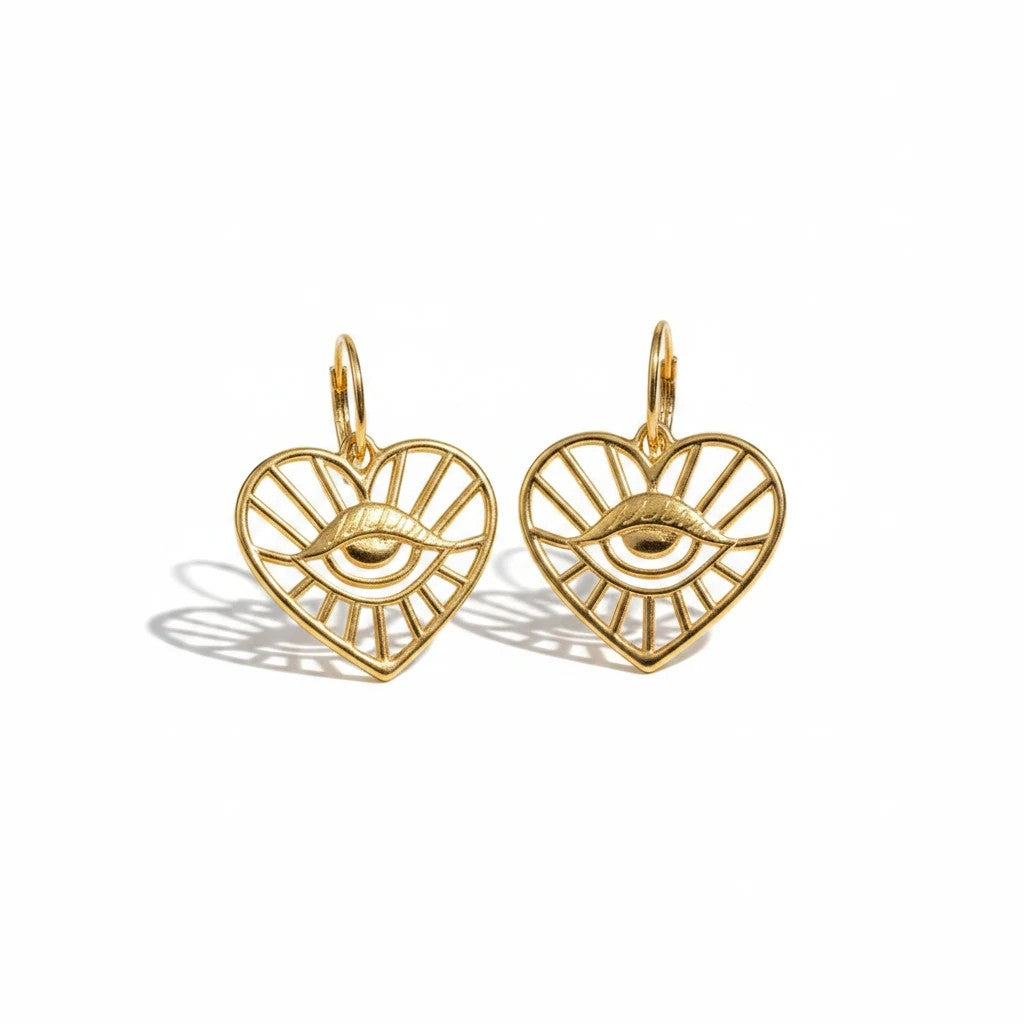 elephantina.gr gold-tone brass hoop earrings featuring a heart-shaped charm with an intricate evil eye design.