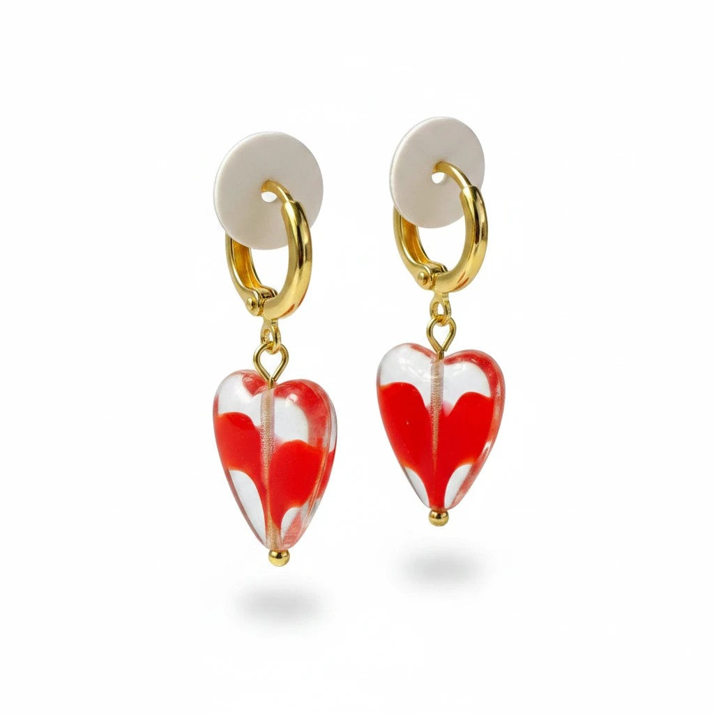 elephantina.gr handmade brass hoop earrings with dangling red heart charms on a white background.