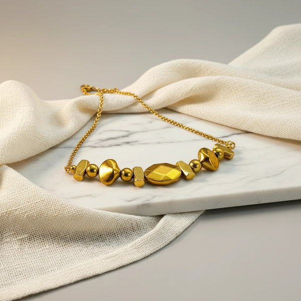Elephantina.gr gold hematite and steel chain necklace with geometric modern design and gold accents.