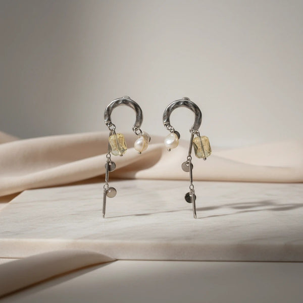 Hammered silver-tone hoop dangle earrings with pale yellow gemstone, pearl, and disc accents by elephantina.gr
