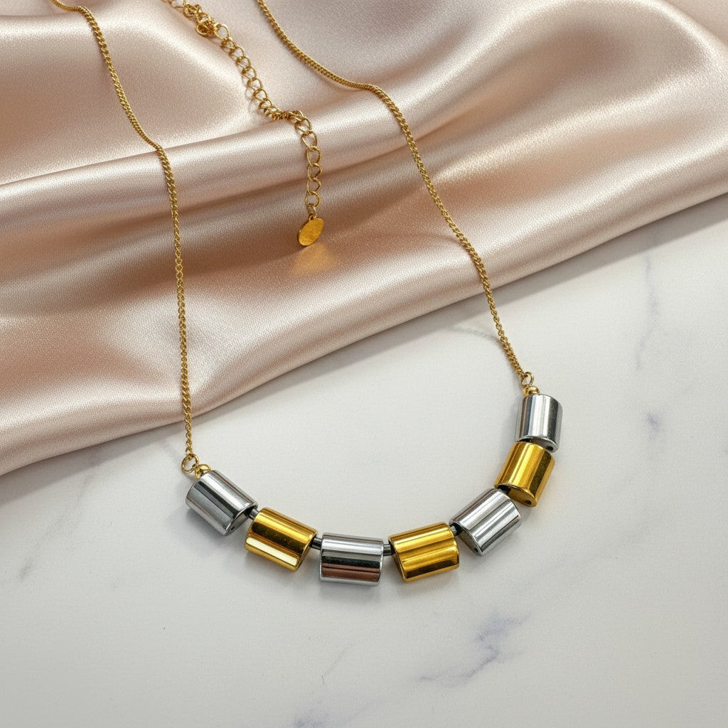 Elephantina.gr gold necklace with cylindrical hematite beads in gold and silver, minimal modern design, 40+5cm extension.