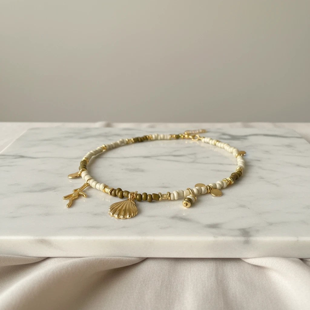 elephantina.gr two-tone beaded necklace with gold seashell, starfish, and pearl charms. 40cm + 5cm extension.
